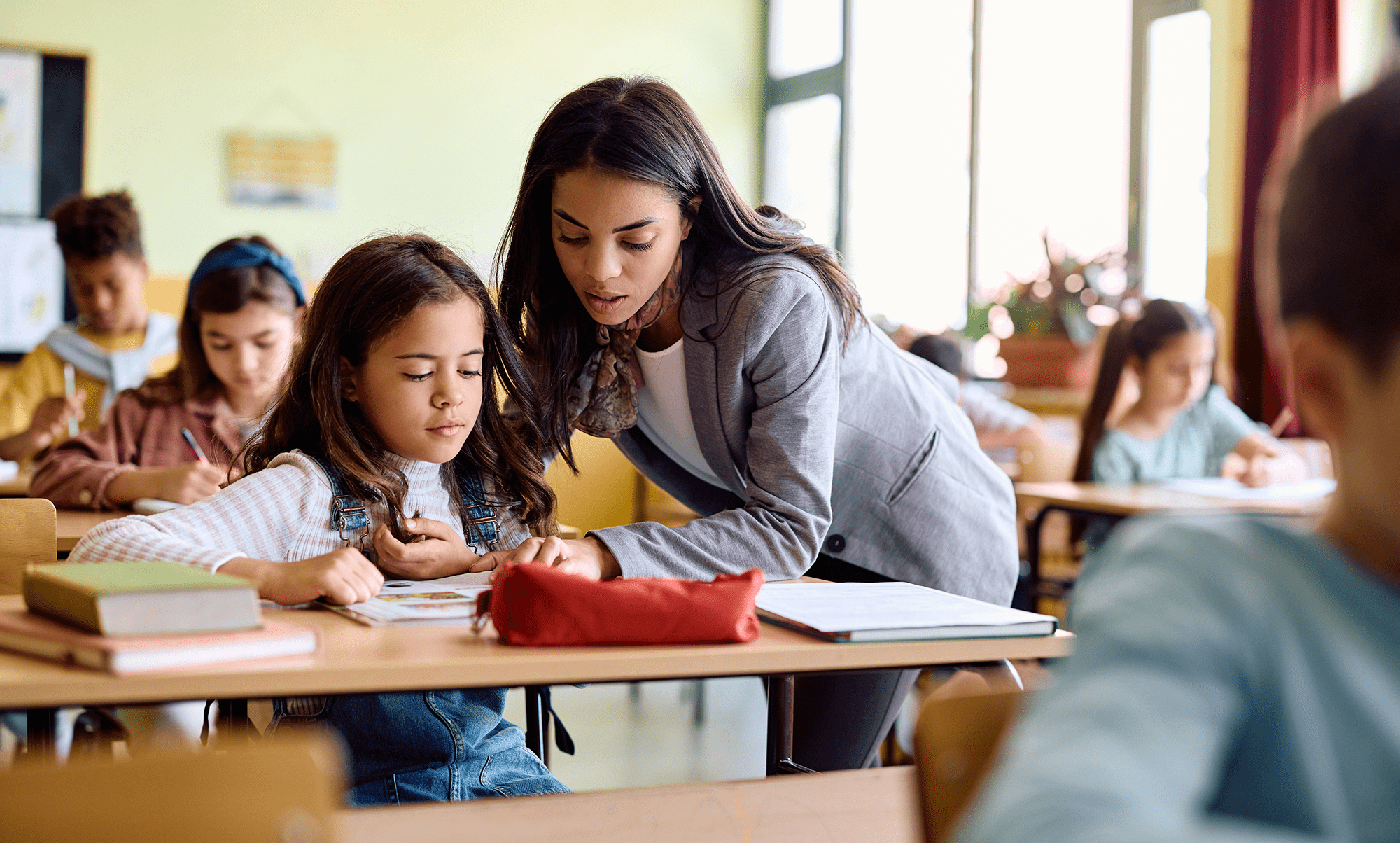 Teacher helping elementary school sttudent